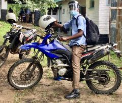 A member of the Coverso project study team sat on a motorbike