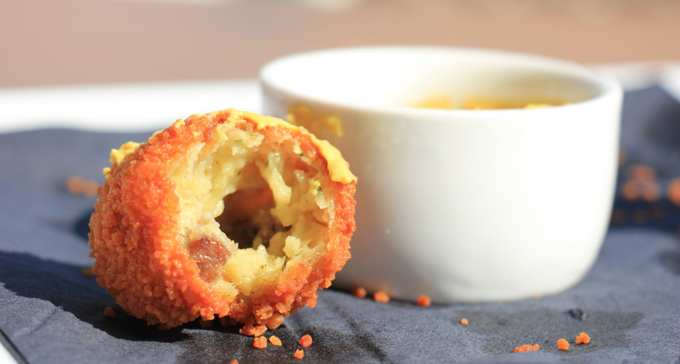 Dutch Bitterballen next to a bowl of mustard [Photo: Shutterstock]