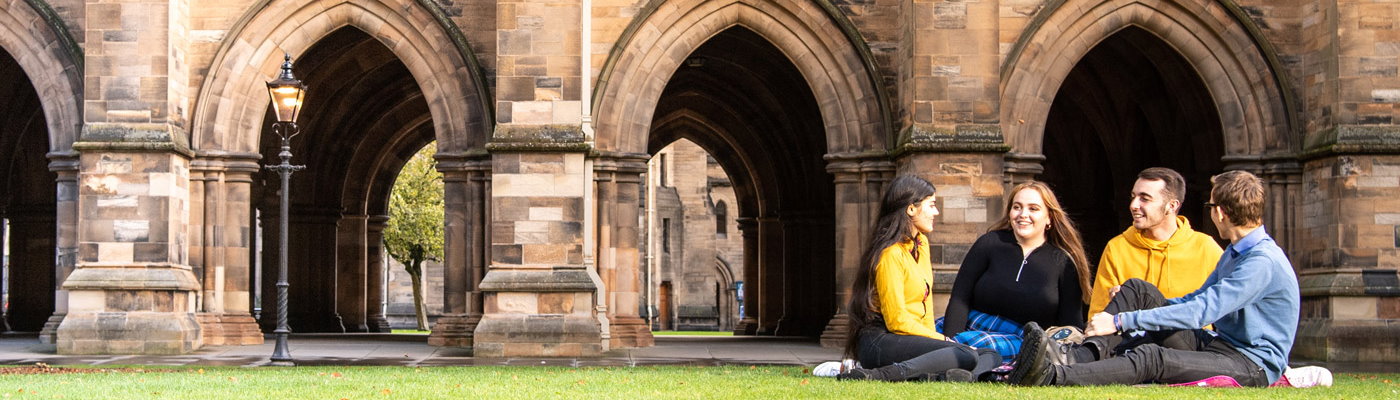 Students sitting on the grass in the west quadrant