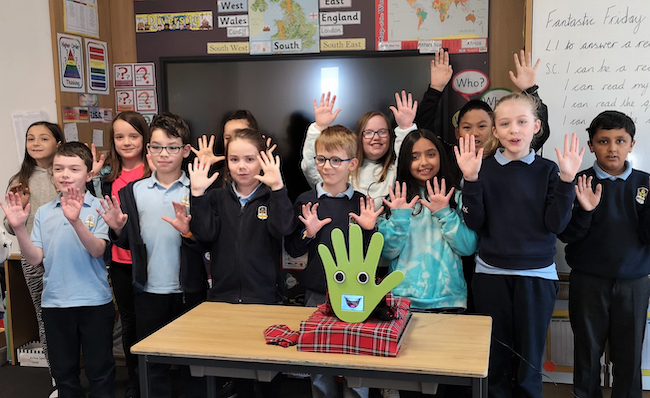 Pupils from Broomhill Primary School pose with handwashing robot WallBo