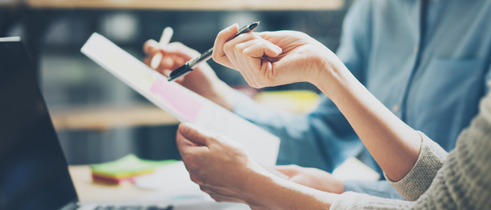 Photo of two people working together