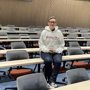 person sitting on desk in lecture theatre