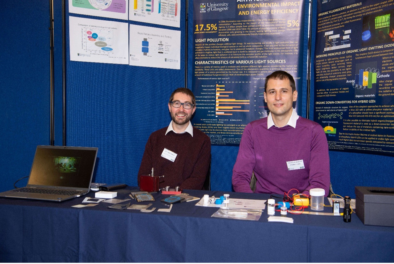 Two academic staff in front of a poster board