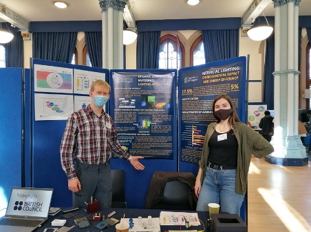 two students in front of a poster board