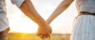 Image of a couple holding hands outdoors