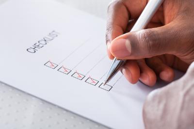 Close-up Of Hand With Red Pen Marking A Check Box