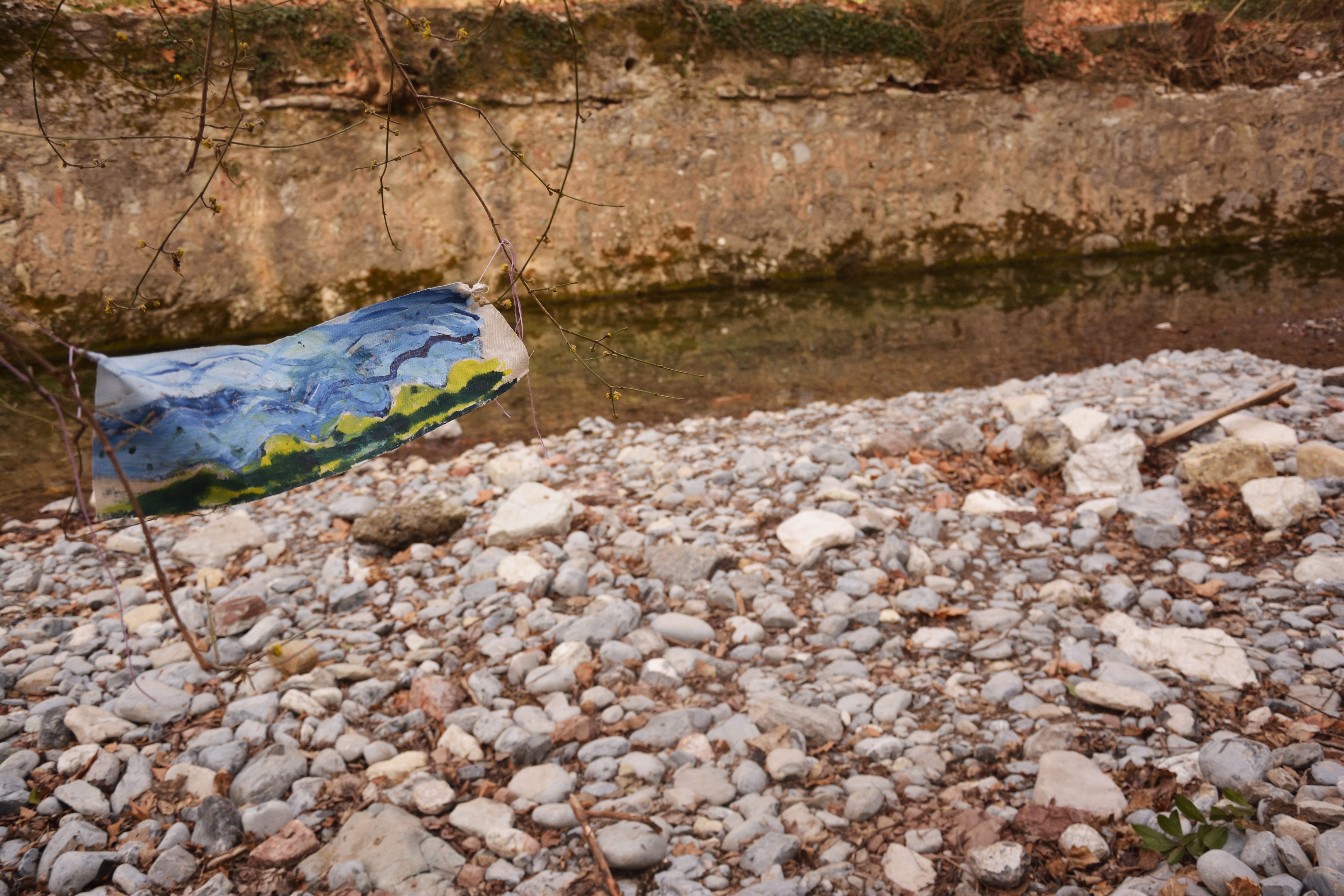 Painting laid beside a river