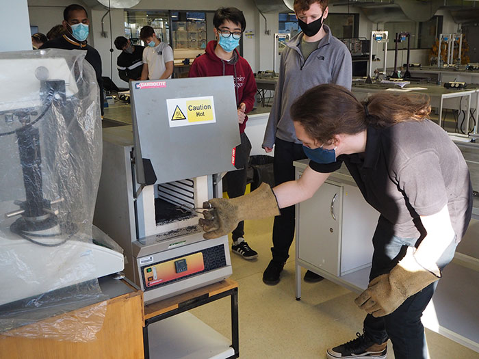 Image of Jonny Horncastle helping students in a teaching lab.