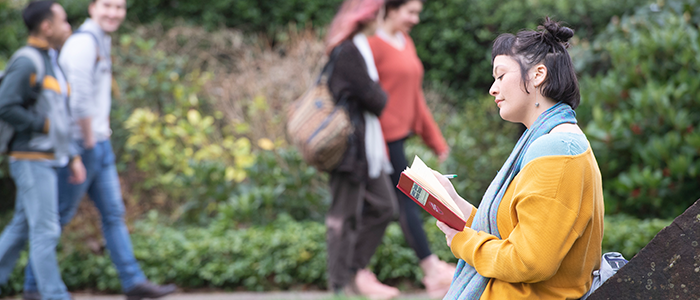 Student reading on Dumfries campus 