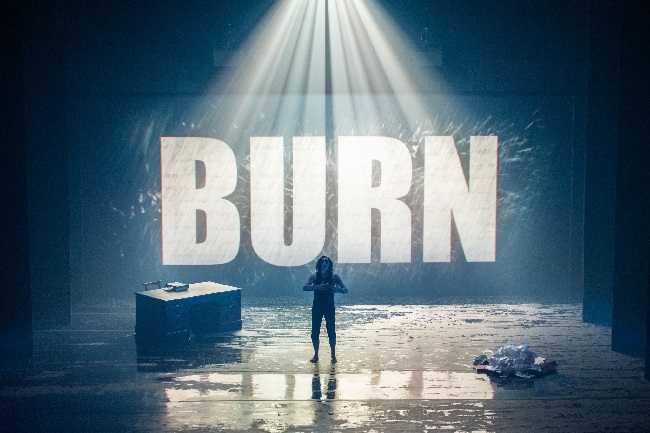 An image of Alan Cumming as Robert Burn on a stage with the words BURN behind him. Credit Tommy Ga-Ken Wan