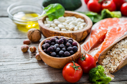 Close up of fruits, vegetables, nuts, fish and beans