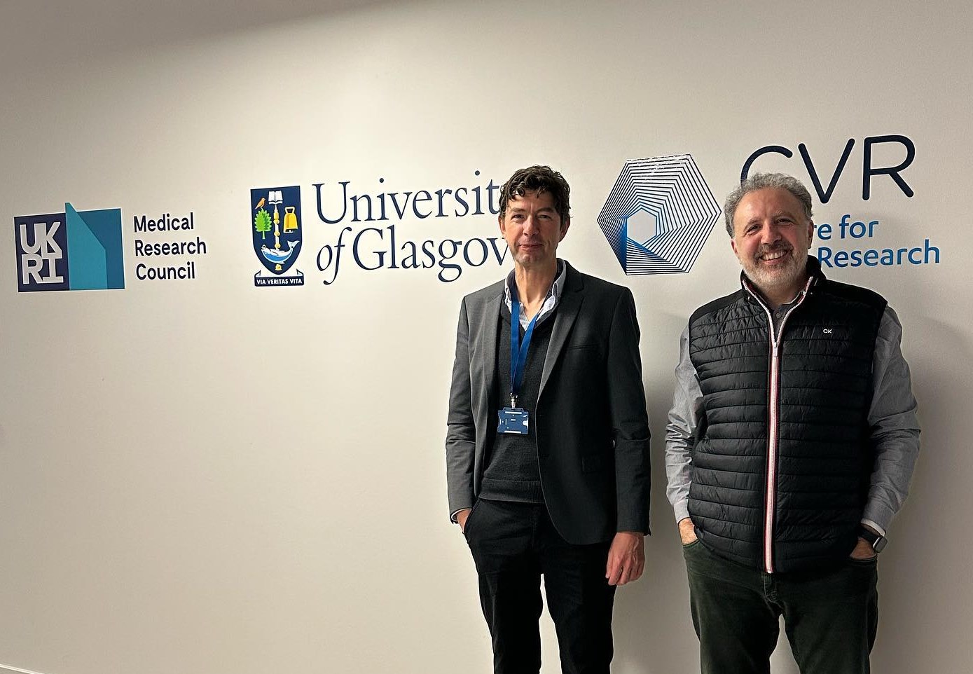 2022 CVR Stoker Award Winner Professor Christian Drosten stood beside CVR Director Professor Massimo Palmarini under the CVR logo 