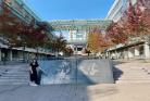 A Student Standing in front of Kyushu University