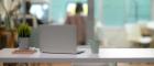 Photo of a laptop, plant and cup of coffee on a desk