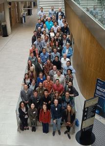 Several people standing on stairs in a tiered system smiling